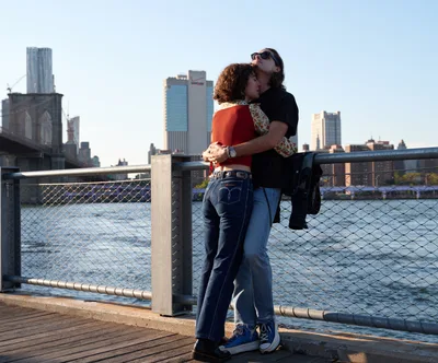 Couple Embraces Against Manhattan Skyline at Sunset