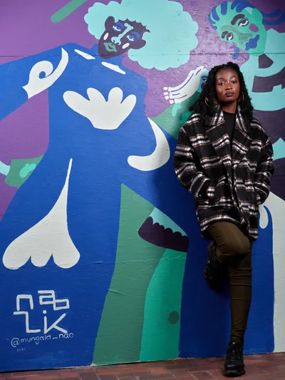 Artist Before Her Mural in Downtown Portland