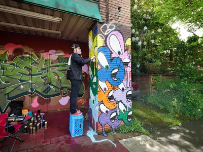 Street Artist Transforms Division Street Wall