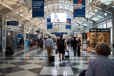 Travelers Navigate O'Hare Terminal Concourse